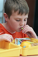 boy eating packed lunch
